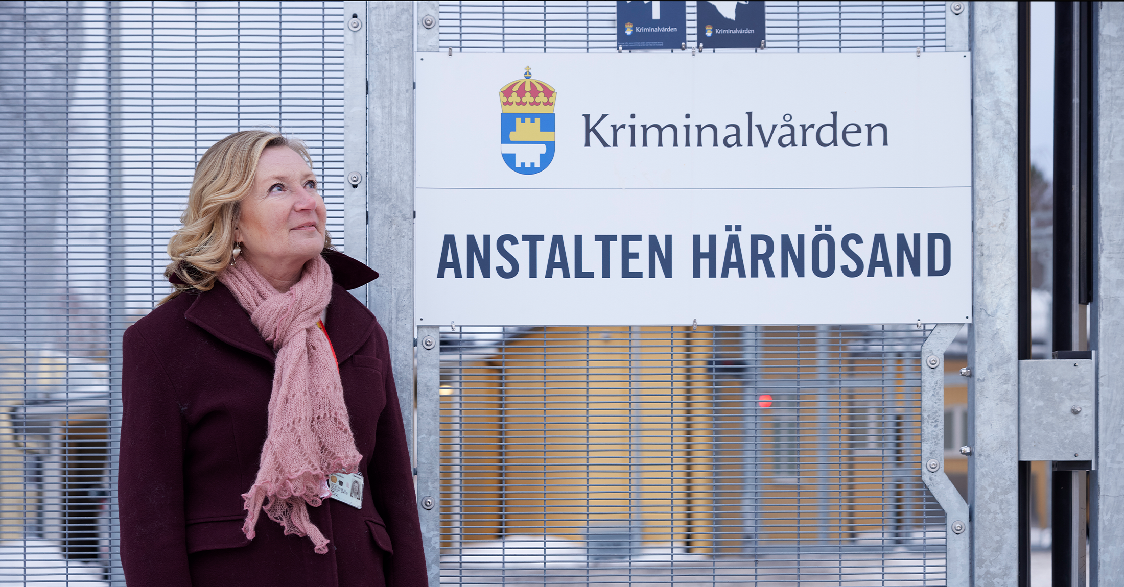 Marlene Boman framför skylt där det står kriminalvården härnösand